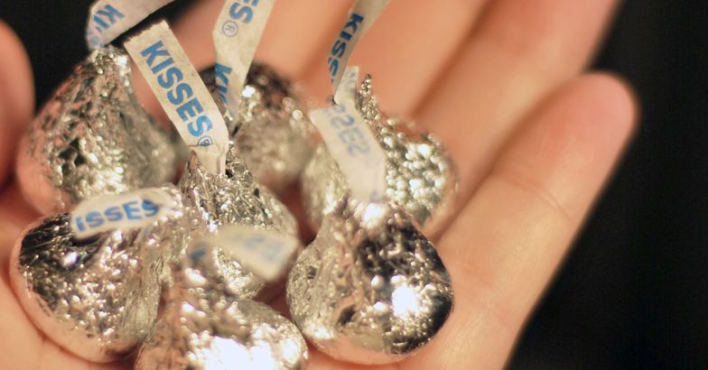 hand holding Hershey Kisses in palm