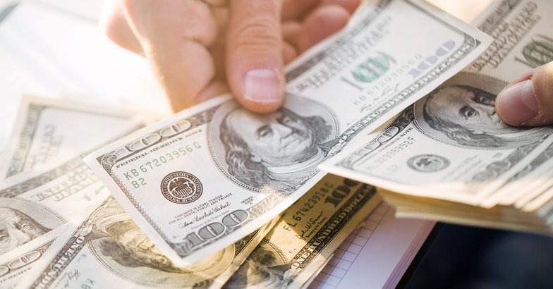 Hand placing money down