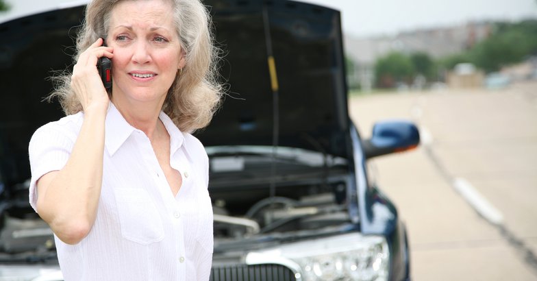 worried senior calling for help with her car