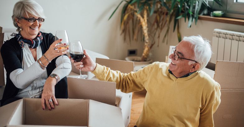 happy elderly couple moving to new apartment