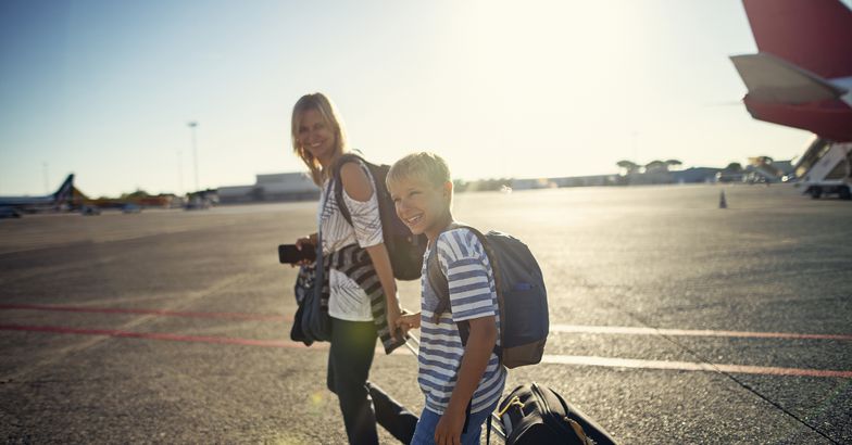 mother and son walking on airstrip