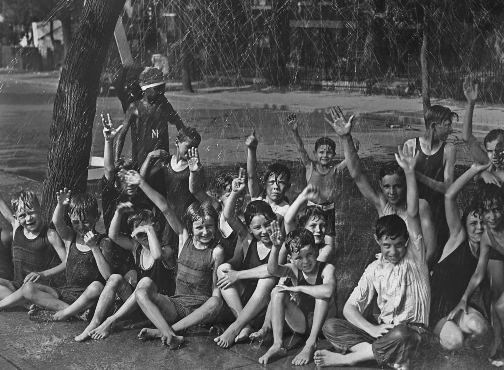 Children enjoyed a “street shower” to cool off from the heat wave that hit Washington, DC, in 1925.
