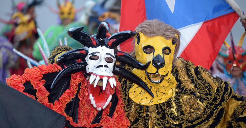 people in costumes and masks at ponce carnival, 2016