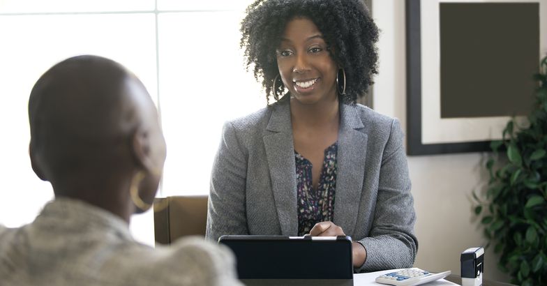 businesswoman in an office with a client giving legal advice about taxes