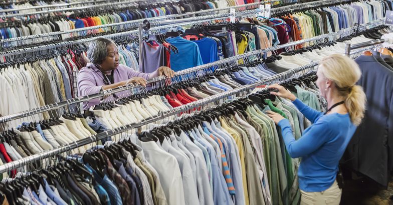 two women working in clothing goodwill store