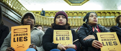 Protestors attend a New York City Council Finance Committee hearing titled 'Amazon HQ2 Stage 2: Does the Amazon Deal Deliver for New York City Residents?