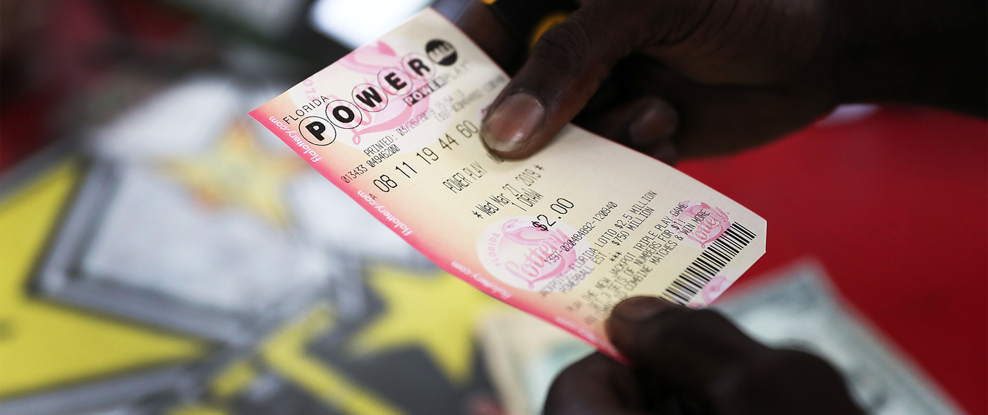 man holding powerball lottery ticket