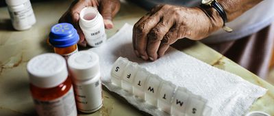 Close-up of senior woman sorting weekly medication