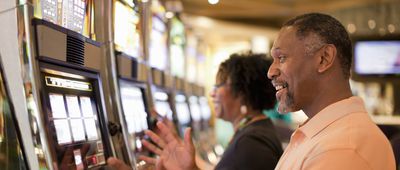 Seniors at casino using slot machine