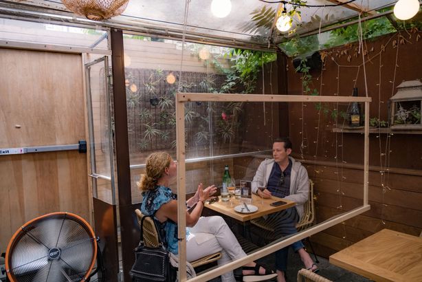 Customers have lunch at a restaurant with social distancing measures in place as the city reopens from the coronavirus lockdown on June 15, 2020 in Hoboken, New Jersey.