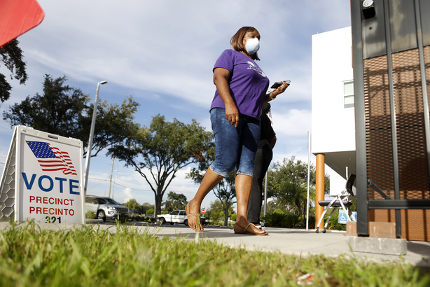 woman walks to voting poll
