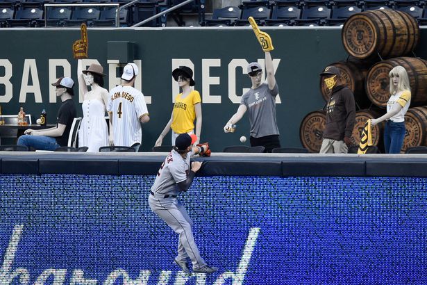 Josh Reddick #22 of the Houston Astros jumps a wall but fails to make the catch on a grand slam hit by Jake Cronenworth #9 of the San Diego Padres 