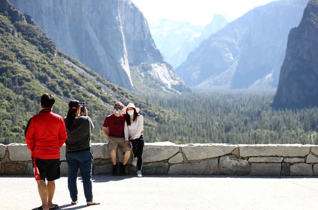 Visitors take pictures at the Tunnel View lookout on June 11, 2020 in Yosemite National Park, California
