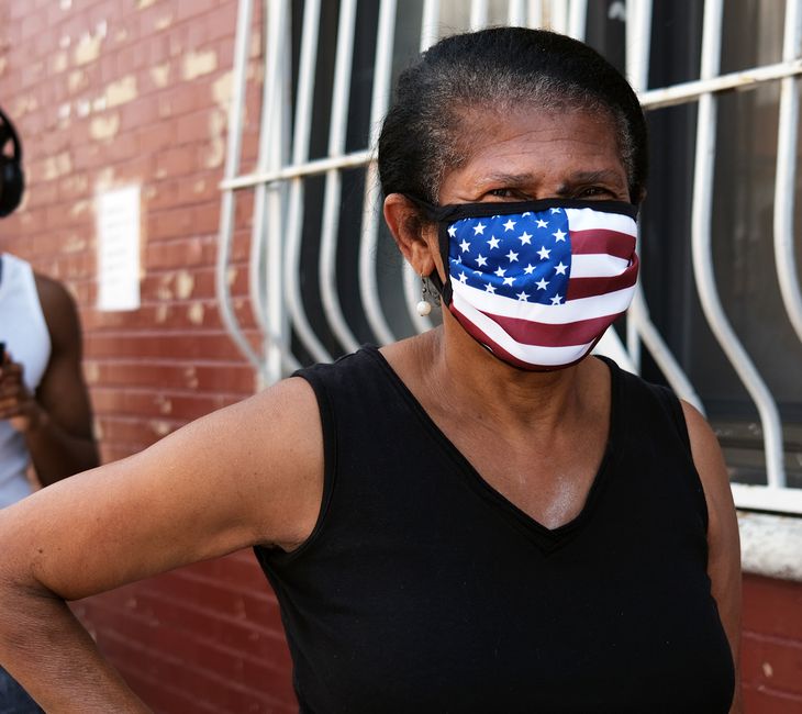 A woman waits in line as food is distributed at the Ebenezer Seventh-day Adventist church on July 22, 2020 in the Brooklyn borough of New York City.