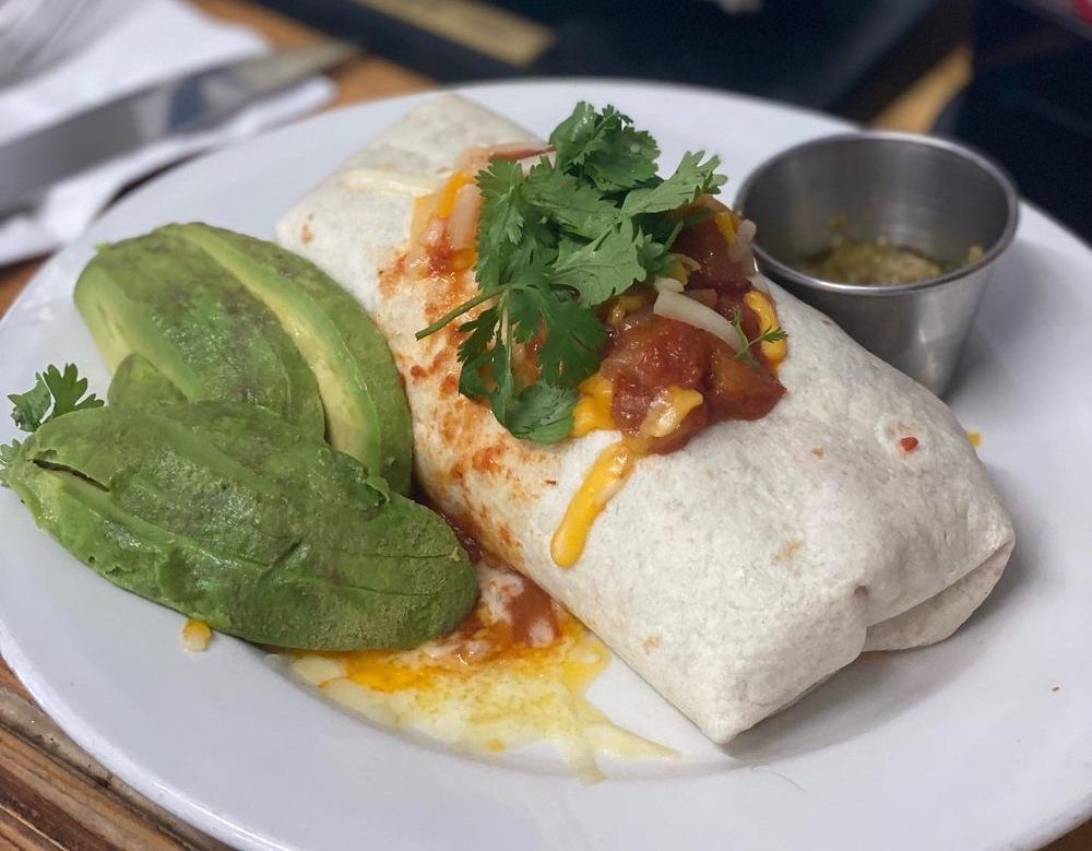 a breakfast burrito on a plate