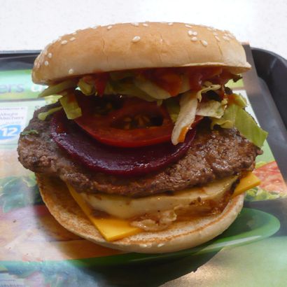 A Kiwiburger with its top bun opened for its inside reference