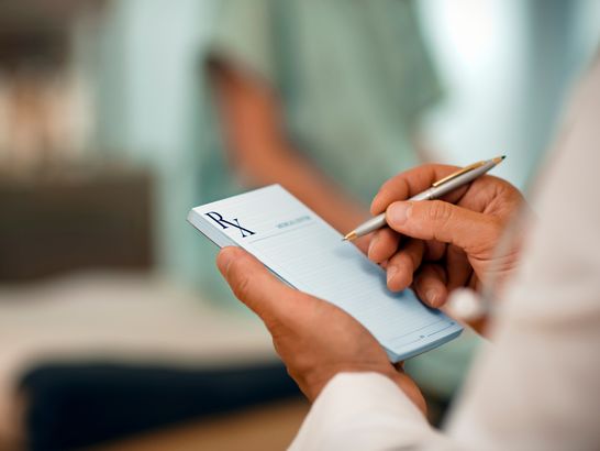 Doctor filling out RX prescription