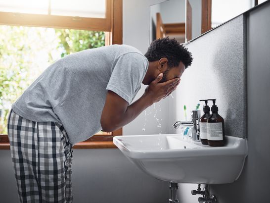 Washing Face in Sink