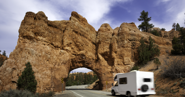 RV approaching a rock tunnel