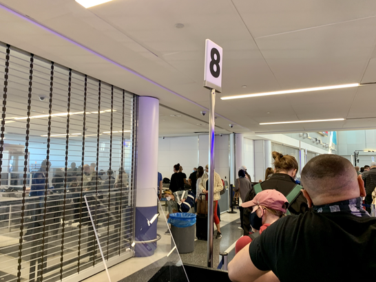 Wonder what it's like to fly during COVID-19? I just did A crowded TSA checkpoint line in EWR