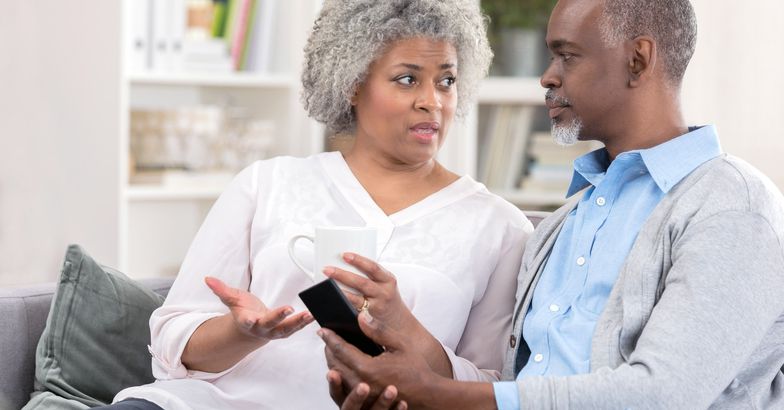 senior couple having serious discussion on couch