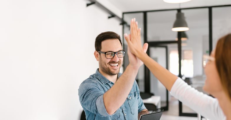 two colleagues high-fiving