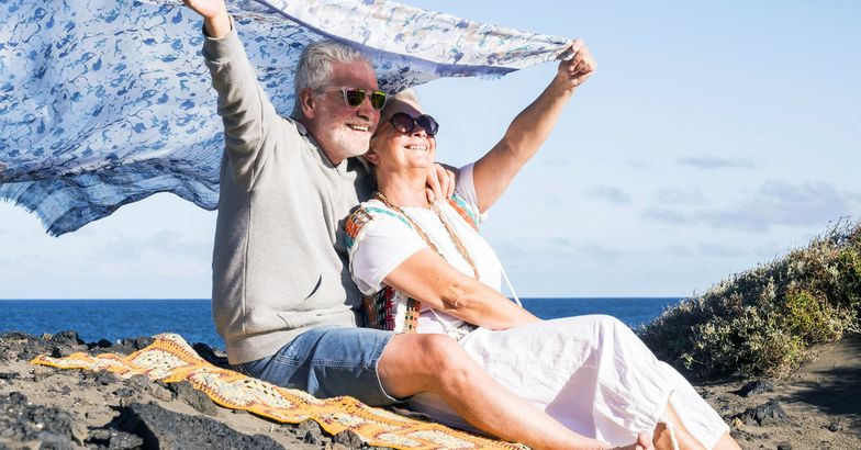 senior couple on beach smiling