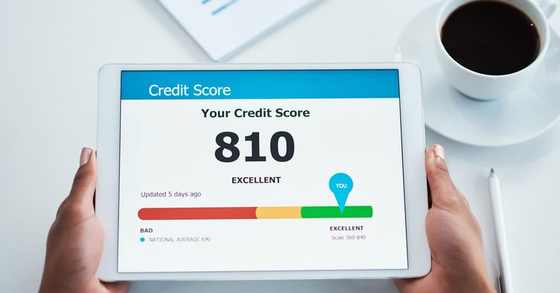 hands holding tablet with credit score open