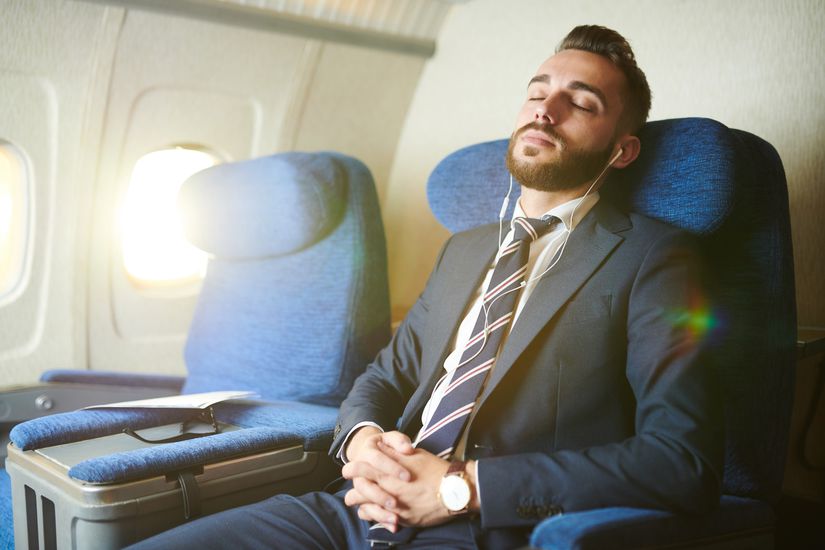 Handsome Businessman Sleeping in Plane