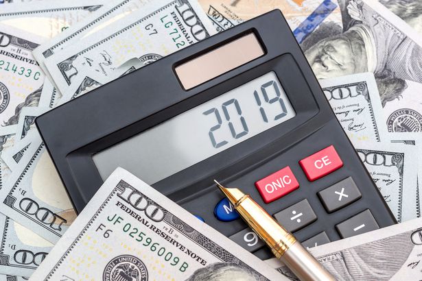 Money Saving New Year S Resolutions To Save 1k Or More This Calculator With Numbers 2019 And Pen On Background Of Dollar Bills