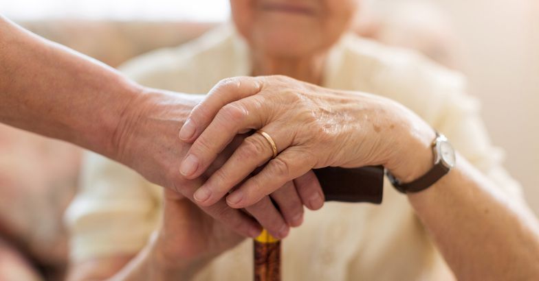 close-up of hands on cane