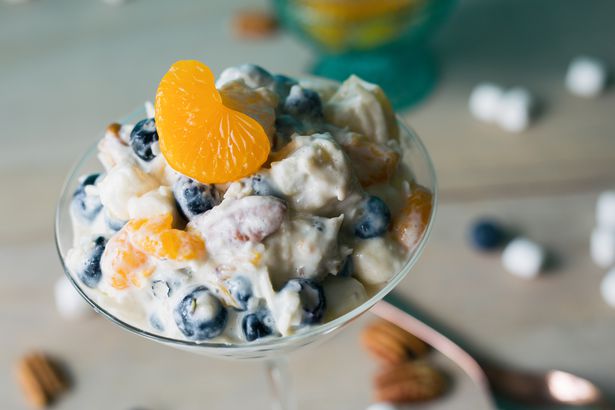 Clementine ambrosia in a martini glass. Made with blueberries, pineapple, coconut, marshmallows and pecans.