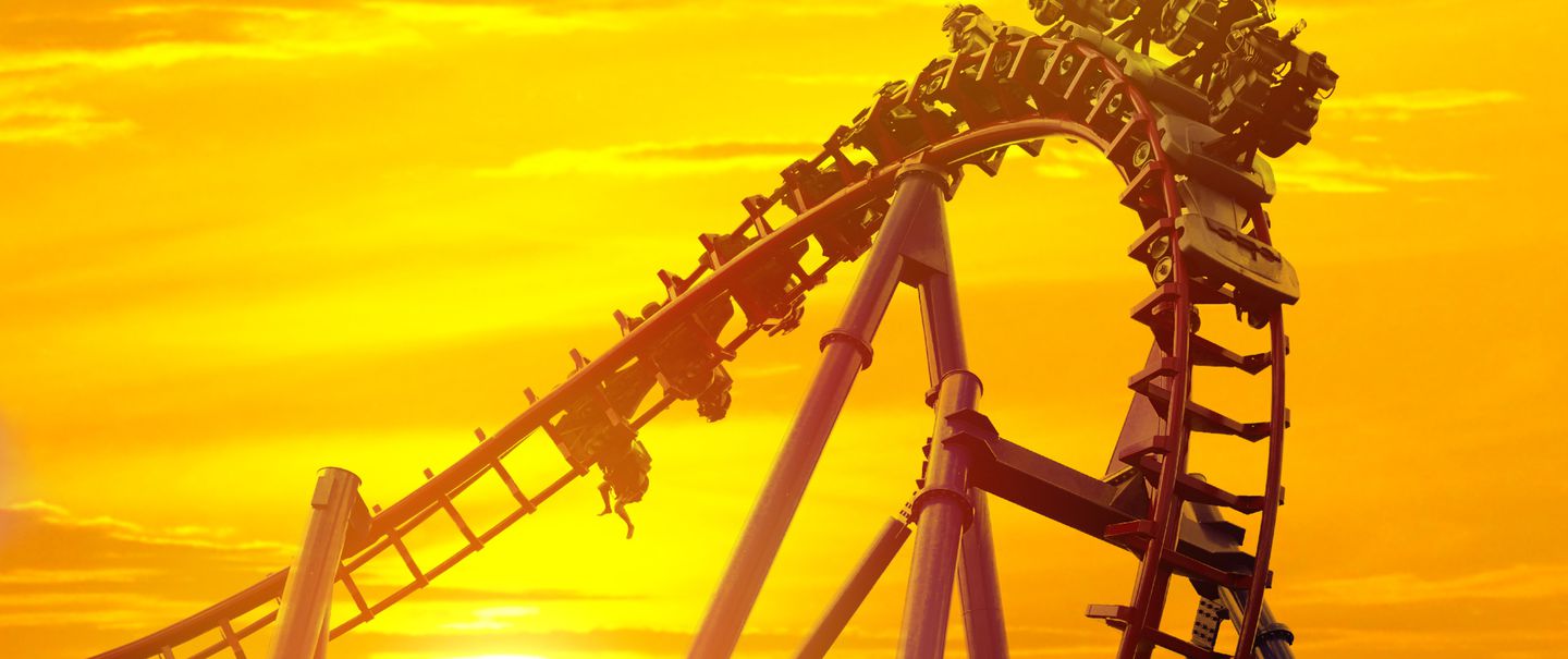 Roller coaster in the amusement park with the sunset background.