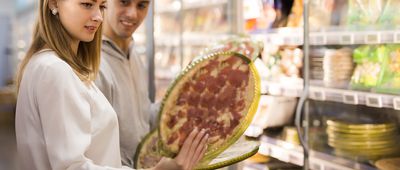 Couple buying frozen pizza