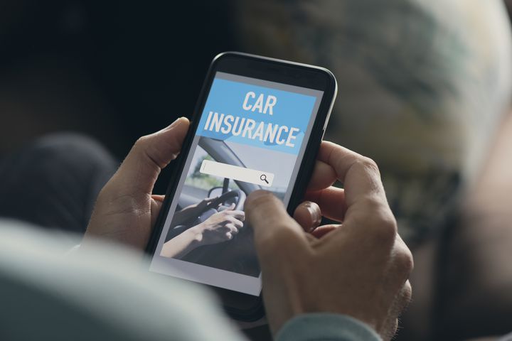man searching a car insurance on his smartphone