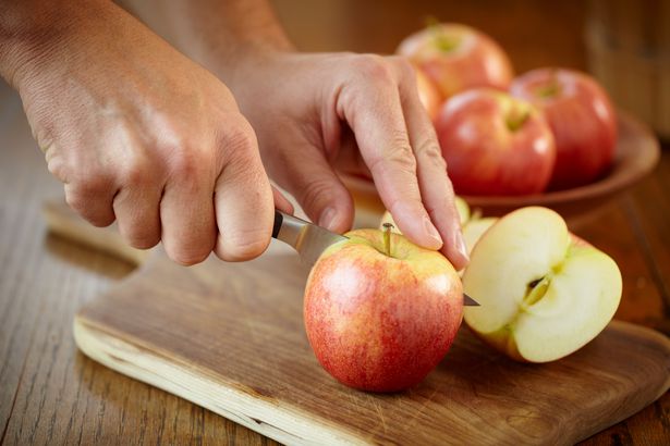 Man cutting gala apples for a snack