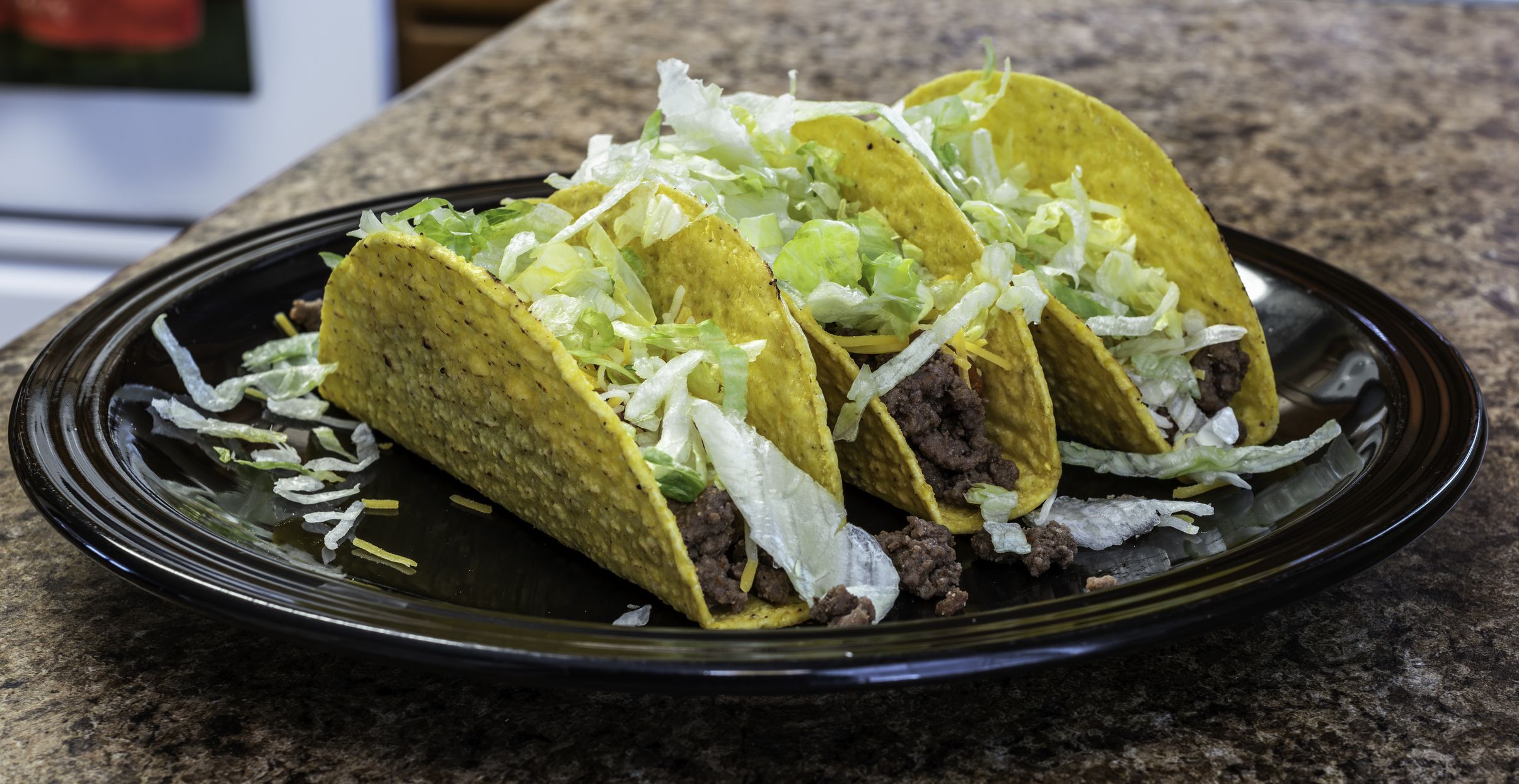 Handmade hard shell ground beef, lettuce and cheese taco