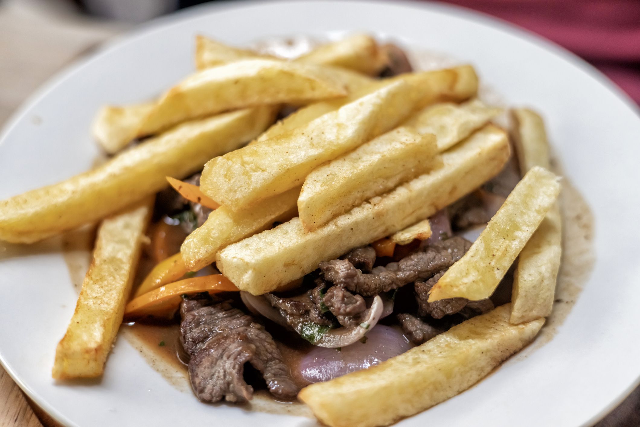 Lomo saltado is a traditional Peruvian dish, a stir fry that typically combines marinated strips of sirloin (or other beef steak) with onions, tomatoes, French fries.