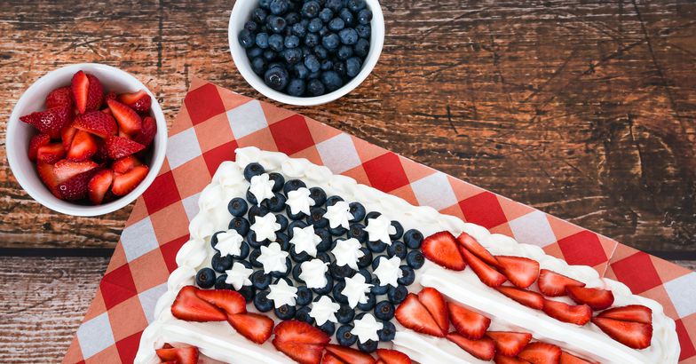 flag cake on wooden surface, blueberries and strawberries