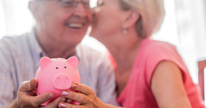 senior couple with piggy bank