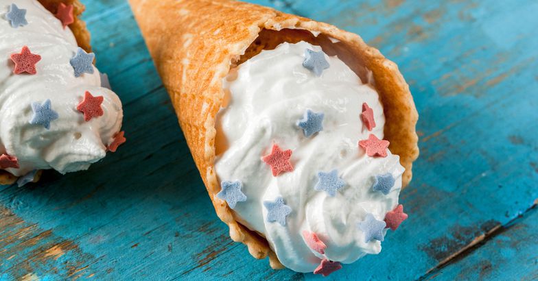 ice cream cone with frosting and red and blue star sprinkles