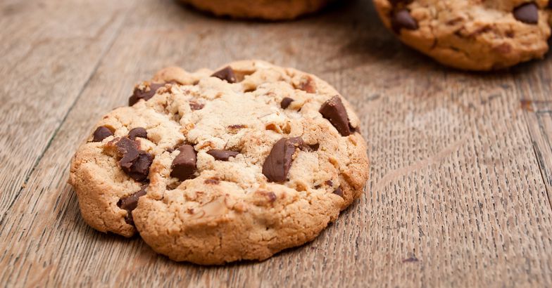 chewy chocolate chip cookies on wooden surface