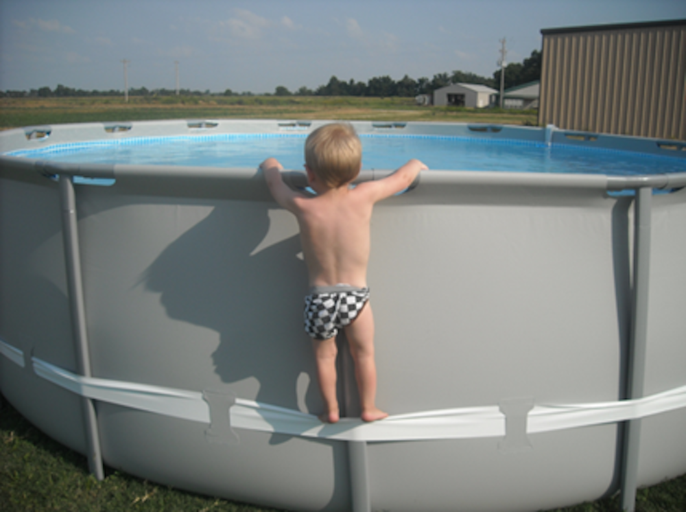 Child Climbing Above Ground Pool